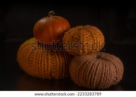 Yellow-orange pumpkins on a black background the concept of Halloween and the autumn harvest of pumpkin close-up copyspace from above