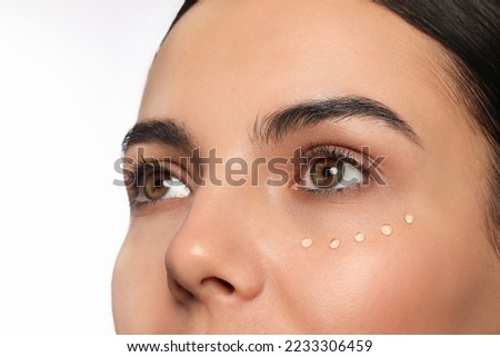 Closeup view of young woman with gel on skin under eye against white background Royalty-Free Stock Photo #2233306459