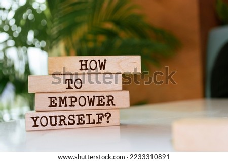 Wooden blocks with words 'HOW TO EMPOWER YOURSELF?'.
