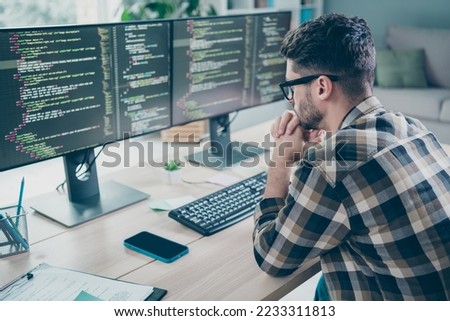 Photo of minded ponder guy wear glasses arms hands chin typig code modern device indoors workstation workshop home