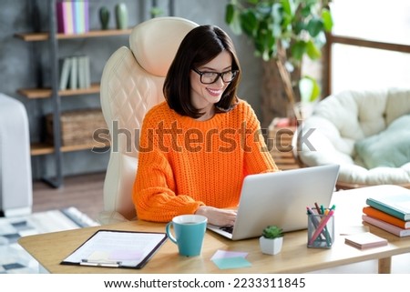 Photo of positive happy lady editor wear sweater writing news information read cv chatting video call conference indoors