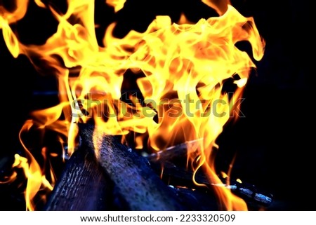 Background of the flame in the oven. Tongues of fire in a brick fireplace. Fire texture.