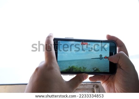 Photos of people using their phones to record video.