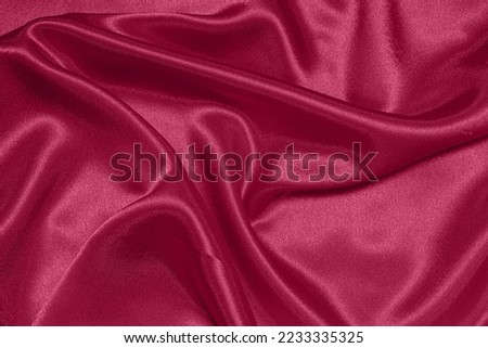 Texture of crumpled satin fabric, color of the year 2023 Viva Magenta. Royalty-Free Stock Photo #2233335325
