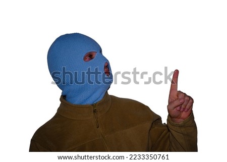 Man in blue balaclava pointing finger at empty space, isolated on white background. Copy space for text