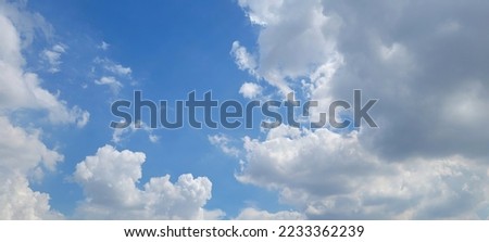 white cloud on blue sky ,  fluffy clouds around blue sky .