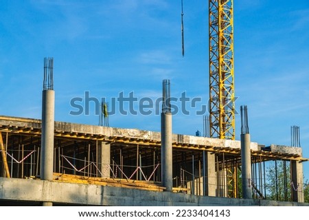 The foundation on reinforced concrete piles and the frame during the construction of a multi-storey building. Reinforcement of reinforced concrete columns. Construction of high-rise buildings. Royalty-Free Stock Photo #2233404143