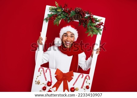 Photo of crazy funky handsome guy arms hold paper decorated album card isolated on red color background