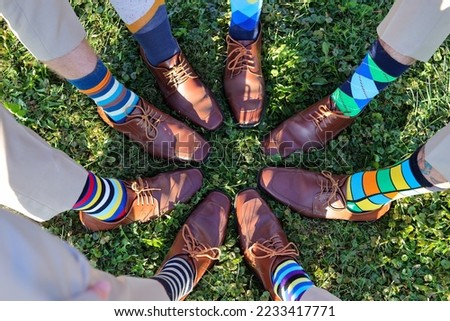Feet and dress shoes of groomsmen at wedding showing off their colorful fancy socks Royalty-Free Stock Photo #2233417771
