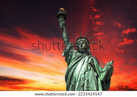 Statue of liberty on dramatic post nuclear war sky background Royalty-Free Stock Photo #2233424547