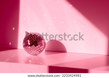 Magenta Disco ball in sunlight with reflections on white background. Geometric shadows Royalty-Free Stock Photo #2233424981