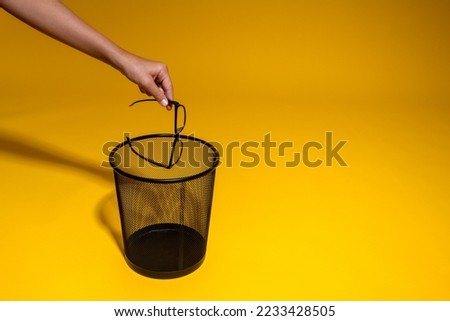 The man throws his glasses into the trash. The concept of laser vision correction. Royalty-Free Stock Photo #2233428505