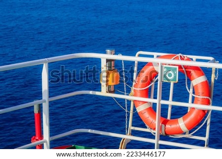 rescue lifebuoy which is installed on supply vessel rail, stand by for man overboard. Emergency equipment for transportation. Life saving appliance on the ship. Lifebouy with line