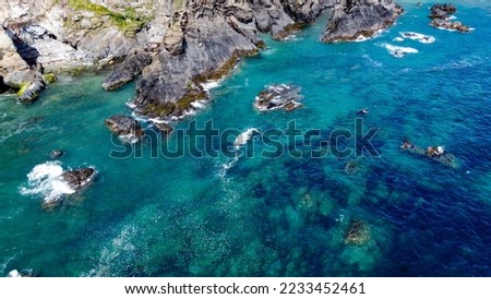 Steep cliffs on the southern coast of Ireland. Turquoise waters of the Atlantic Ocean. Natural beauties of Ireland, West Cork. The rocky coast of the Celtic Sea. Drone photo.
