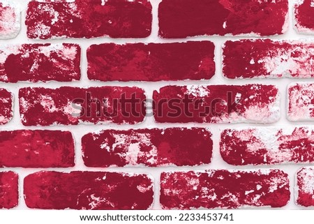 Grunge background of dark classic blue brick wall. Color of the year 2023, viva magenta.