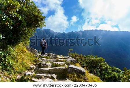 Guy with a Backpack on the Way to Triund Hill, Indrahar Pass Trail, Dauladhar Range, Himachal Pradesh, India Royalty-Free Stock Photo #2233473485