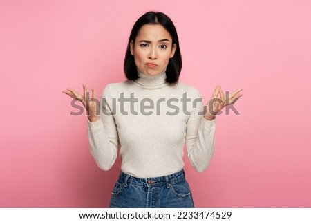 No idea, I don't know! Portrait of uncertain confused girl in sweater expressing doubts and bewilderment, looking at camera with question so what, who cares. Indoor studio shot pink background  Royalty-Free Stock Photo #2233474529