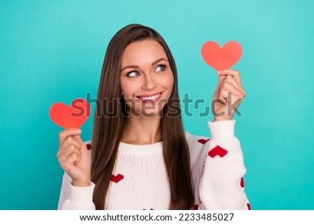 Portrait of gorgeous nice girl toothy smile look arms hold little heart cards isolated on cyan color background Royalty-Free Stock Photo #2233485027
