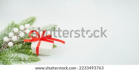 banner beautiful christmas gift box in red color with bow on white christmas tree background