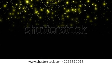 Image of glowing yellow spots falling on black background. Colour, light and movement concept digitally generated image.