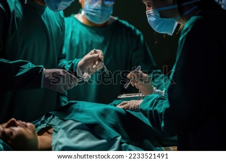 A team of professional doctors perform surgery in a hospital, a group of surgeons working in the operating theater.