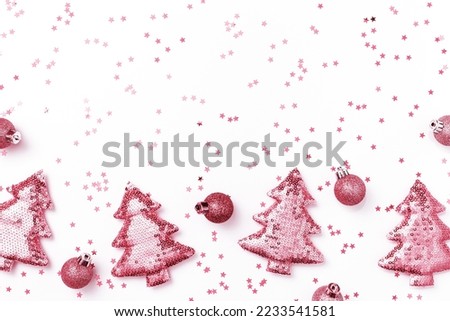 Christmas holiday magenta decorations trend sparkling xmas toys from metallic sequins, shining Christmas trees on white background, copy space. New Year Happy holidays concept, color of year 2023