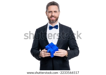 happy tuxedo man with occasion present isolated on white background. man with occasion gift