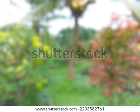 abstract blurred of beautiful green garden around the house.