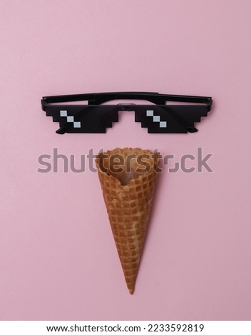 Waffle cone with Pixelated 8 bit sunglasses on pink background