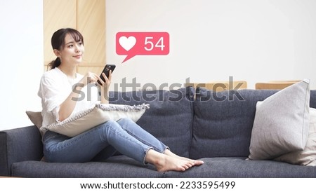 Young woman operating a smartphone