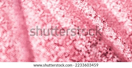 toned abstract bokeh background. Texture with glowing blurry lights in the trendy color of the year viva magenta 2023. New Year, Christmas festive background. Blurred magenta lights.