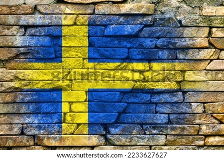 Flag of Sweden. Flag is painted on a stone wall. Stone background. Textured creative background