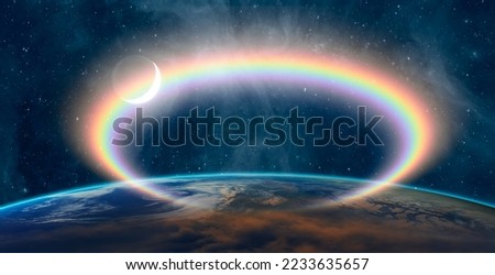 Rainbow surrounds the Planet Earth with crescent "Elements of this Image Furnished by NASA"