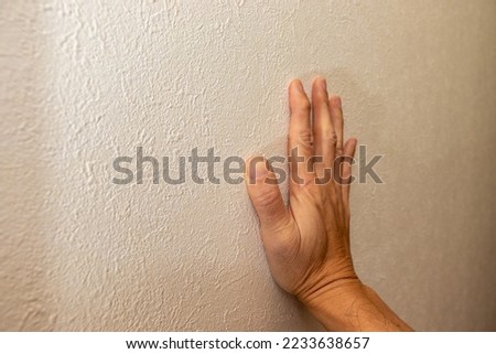 Put right hand gently against the wall