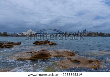 Sydney Harbour Australia at Sunset with the turquoise colours of the bay and high rise offices of the City in the background