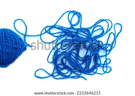 A skein of thread lies on a white isolated background. Tangled threads. Royalty-Free Stock Photo #2233646215