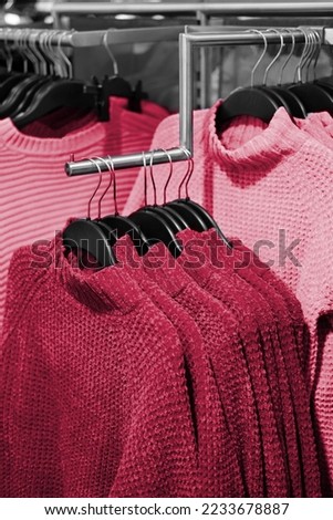 Winter sweater on store shelves. New 2023 trending PANTONE 18-1750 Viva Magenta colour