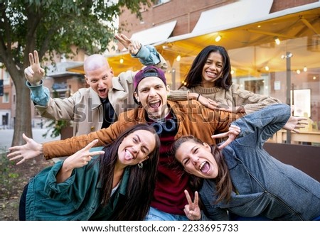 Friends group having fun outside - Happy people taking picture screaming at camera - 
Young crazy guys together at city center - Community and friendship - Focus on central man