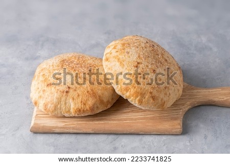 Pita bread on wooden board on neutral background. Georgian cuisine. Spanish food. National cuisine. Traditional dish Royalty-Free Stock Photo #2233741825