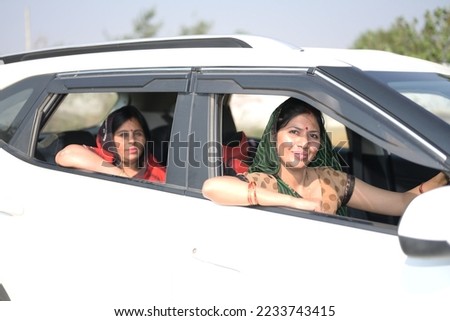Portrait of an Indian woman sitting inside a car