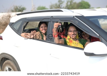 Portrait of an Indian woman sitting inside a car