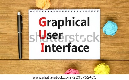 GUI graphical user interface symbol. Concept words GUI graphical user interface on white note on a beautiful wooden background. Business and GUI graphical user interface concept. Copy space.