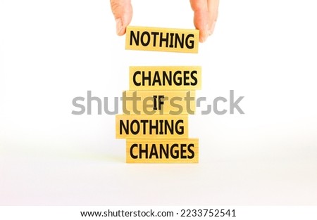 Nothing change symbol. Concept words Nothing changes if nothing changes on wooden blocks. Businessman hand. Beautiful white table white background. Business nothing changes concept. Copy space.