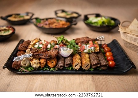 Assorted mix grills with tikka boti seekh kabab of chicken, beef, lamb, mutton bbq platter served in dish isolated on table top view of arabian food Royalty-Free Stock Photo #2233762721
