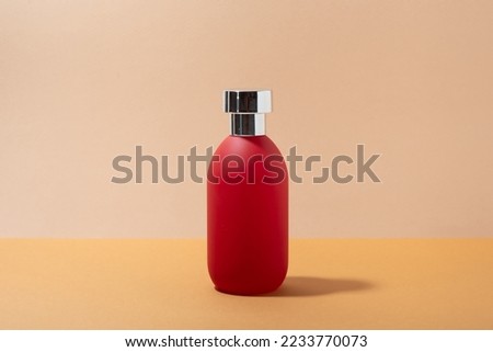 Red bottle of toilet water, close-up
