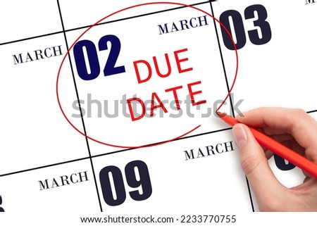 2nd day of March. Hand writing text DUE DATE on calendar date March 2 and circling it. Payment due date. Business concept. Spring month, day of the year concept. Royalty-Free Stock Photo #2233770755