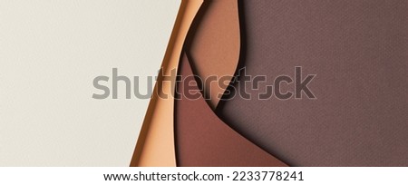 Abstract colored paper texture background. Minimal paper cut style composition with layers of geometric shapes and lines in shades of beige and brown colors. Top view