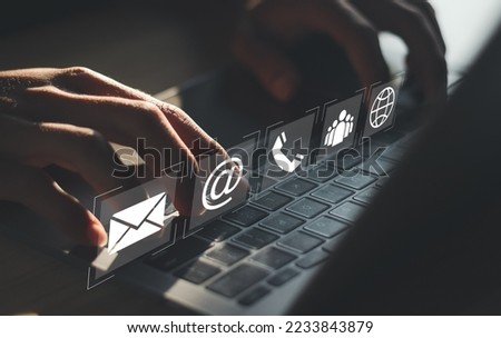 Businessman using laptop pc with contact icons on virtual screen. searching web, browsing information, Contact us or Customer support hotline people connect.