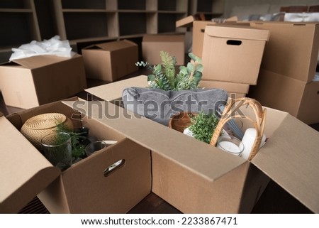 Open cardboard logistic boxes with housing stuff close up. Mess of paper containers placed on floor of new home, flat, apartment after delivery, moving, relocation Royalty-Free Stock Photo #2233867471