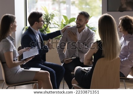 Company boss praising promoted employee, express respect, showing thumbs up, sign of acceptance and approval, during group meeting with staff in office. Corporate career growth, reward, recognition Royalty-Free Stock Photo #2233871351